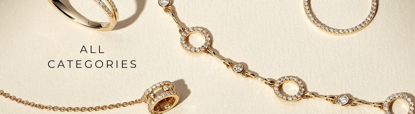 A bright, flat-lay studio shot of various pieces of designer diamond jewelry on a cream-colored surface. The image shows a partial view of a gold pavé ring, a circle-shaped earring, and a statement necklace featuring a chain of diamond-encrusted circles and bezel-set solitaire diamonds. The text "ALL CATEGORIES" is on the left. This image highlights designer diamond rings, earrings, and necklaces as elegant accessories.