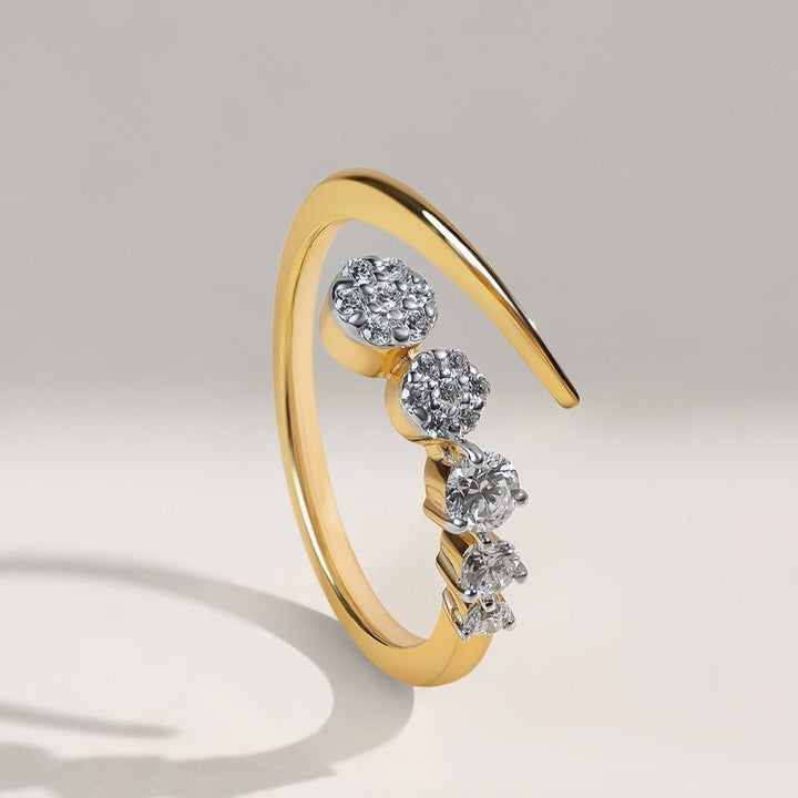 Angled view of gold Descend Ring featuring a descending diamond cluster arrangement.