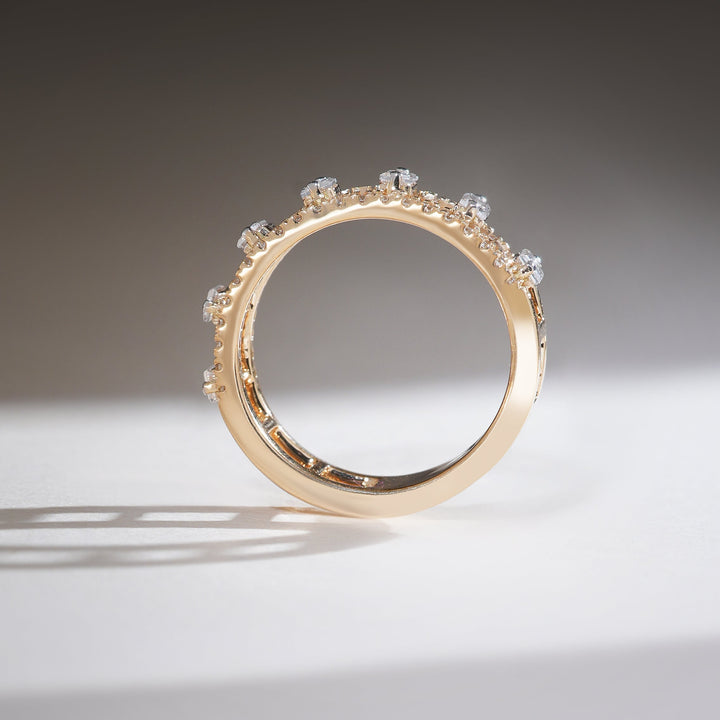 Profile view of gold half-eternity band with raised baguette diamond setting