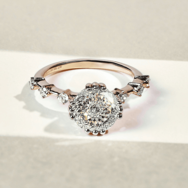Yellow gold ring with a Portuguese cut diamond and smaller diamonds on the band