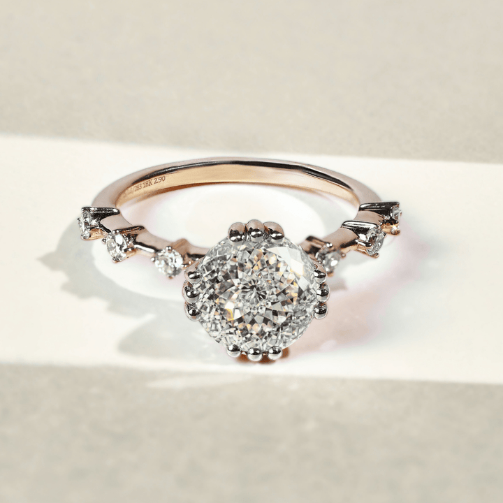 Yellow gold ring with a Portuguese cut diamond and smaller diamonds on the band