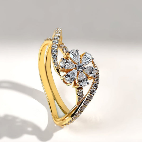 Gold ring with diamond accents on a gradient gray background