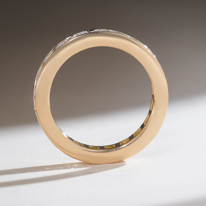Side profile of a 2 Ct Round Fortress Eternity Band in yellow gold, revealing its smooth polished finish.