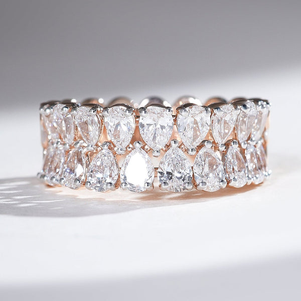 Front view of rose-gold half-eternity band with two rows of pear-cut diamonds.