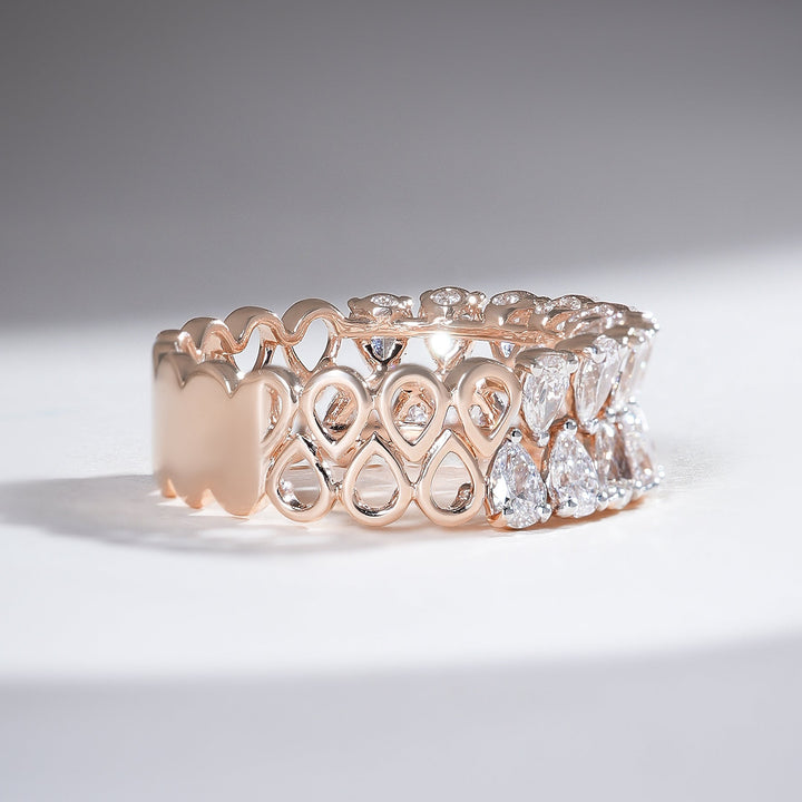 Side angle showing slim shank and raised pear settings along the band.