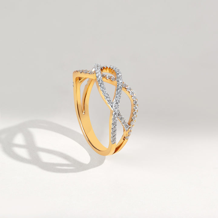 Gold ring with diamond accents on a light gray background