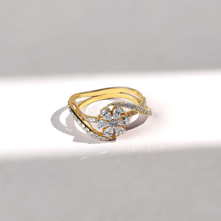 Gold ring with diamond accents on a light gray background