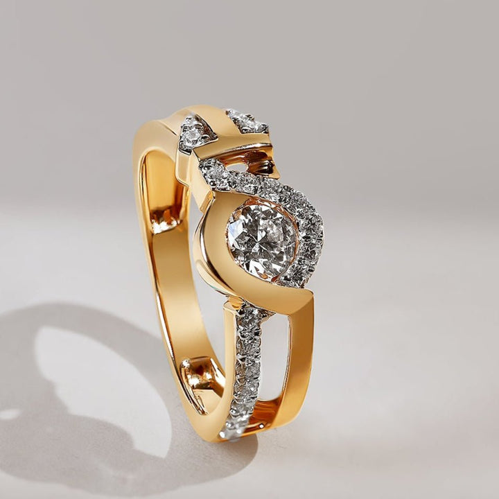 Gold ring with diamonds on a light gray background