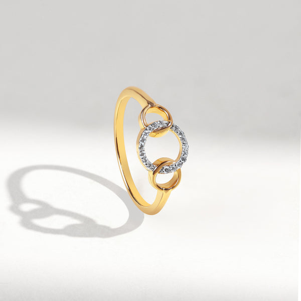 Gold ring with a diamond design on a light gray background