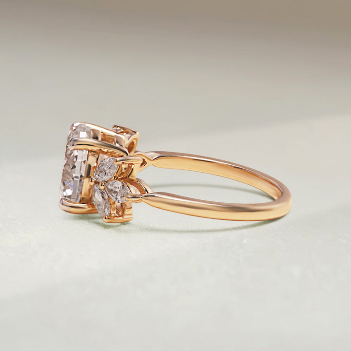 Yellow gold ring with diamond accents on a light gray background