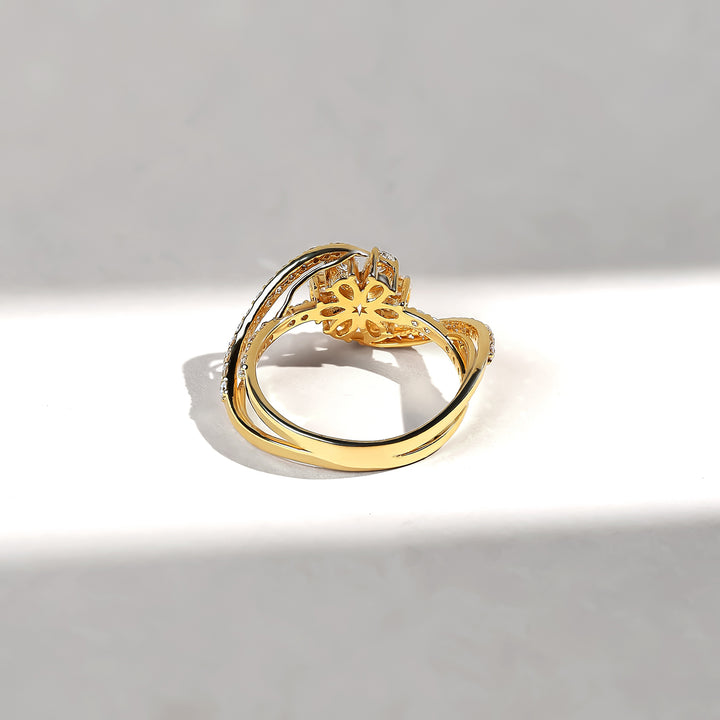 Gold ring with intricate design on a gray background
