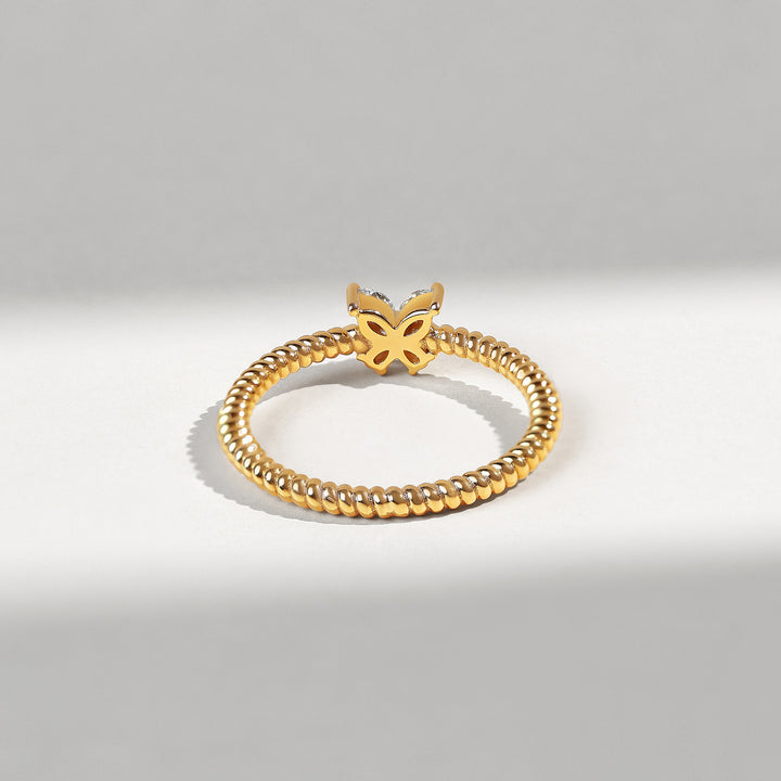 Gold bracelet with a butterfly clasp on a light gray background