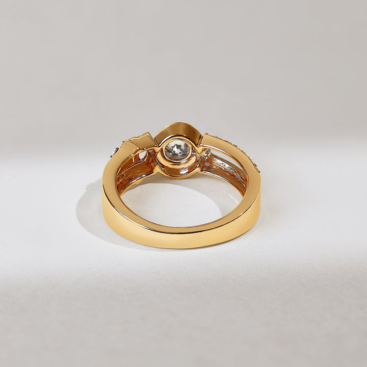 Gold ring with a diamond on a light gray background