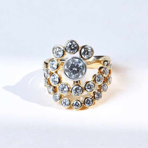 3 carat round ray cocktail ring in yellow gold with bezel-set diamond halo