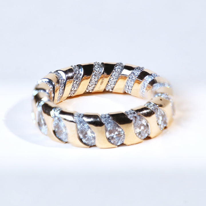 Angled view of Striping Beauty diamond band with teardrop-shaped pavé sections