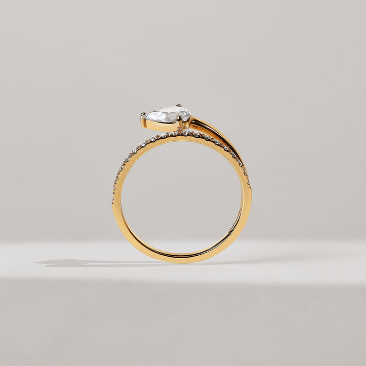 Gold ring with a diamond on a light gray background