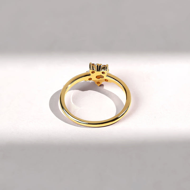 Gold ring with a diamond on a gray background