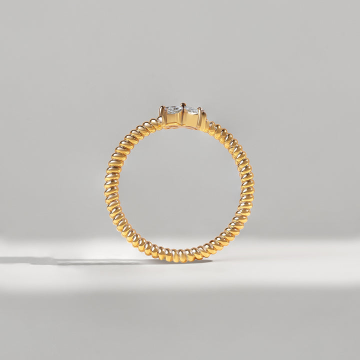 Gold ring with a diamond on a gray background