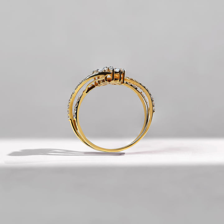 Gold ring with diamonds on a gray background