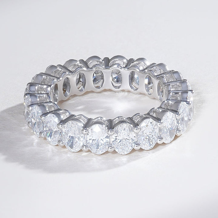 Angled view of 4-carat oval diamond eternity ring in white gold, showcasing brilliance from every angle.