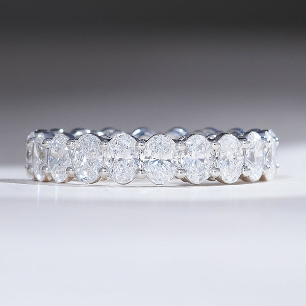 Front view of 4-carat oval diamond eternity band in white gold, featuring a continuous row of perfectly matched stones.