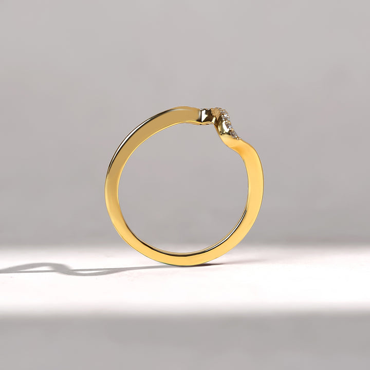 Gold ring with a small diamond on a gray background