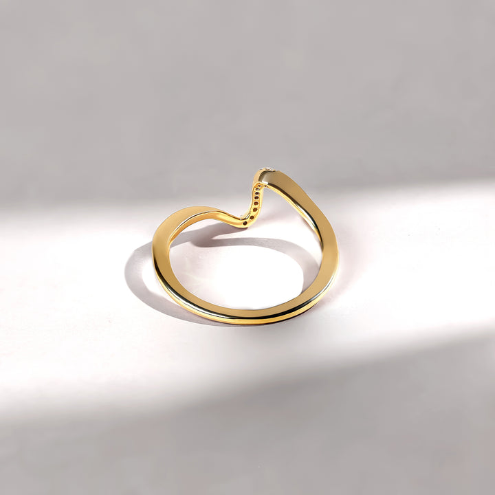Gold ring on a light gray background
