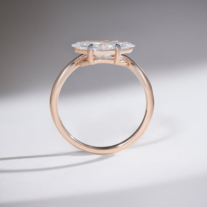 Profile view of the Aveline Marquise Solitaire Ring showing the elegant height and delicate setting of the diamond.