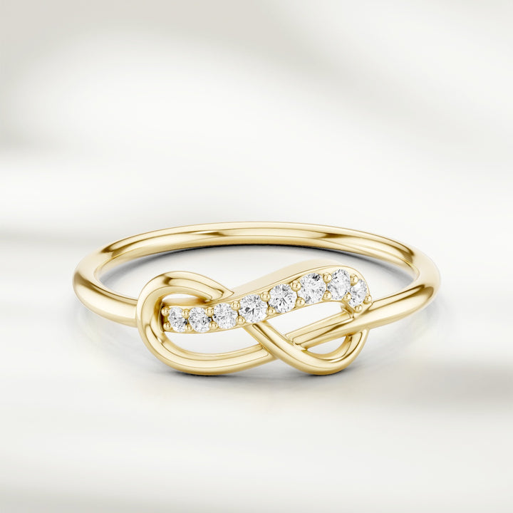 Infinity knot diamond ring in gold with slim polished band