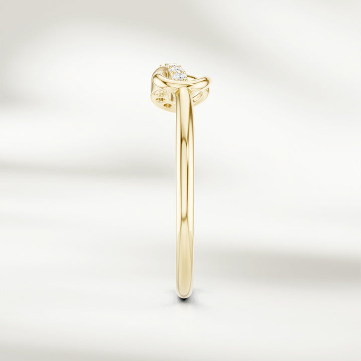 Side profile of gold infinity knot diamond ring with slim polished band