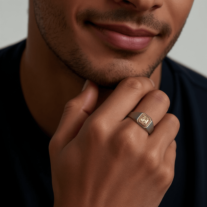 Man wearing 0.8 Ct Colossus Titanium Ring with gold bezel diamond on matte titanium band.