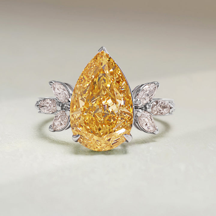 Front view of Golden Bloom Cocktail Ring featuring a pear-shaped yellow diamond with floral diamond accents in white gold.