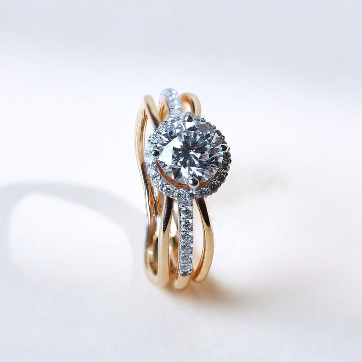 Side angle of Orlo 1 Ct Solitaire Ring highlighting the twisted yellow gold band and halo diamond setting.