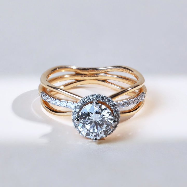 Front view of Orlo 1 Ct Solitaire Ring in yellow gold with halo diamonds and a round solitaire centerpiece.
