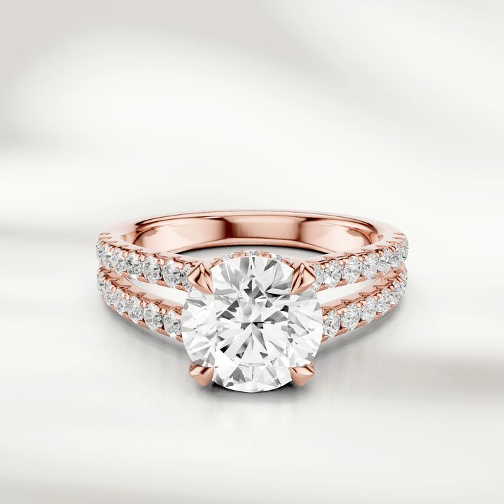 Front view of the 1 Ct Eira Solitaire Ring in rose gold, featuring a round brilliant-cut diamond with a split shank accented by pavé diamonds.