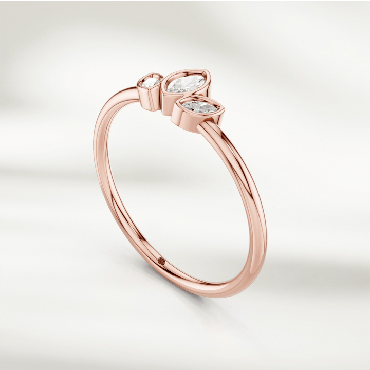 Angled view of gold marquise diamond cluster ring with three marquise diamonds in petal arrangement