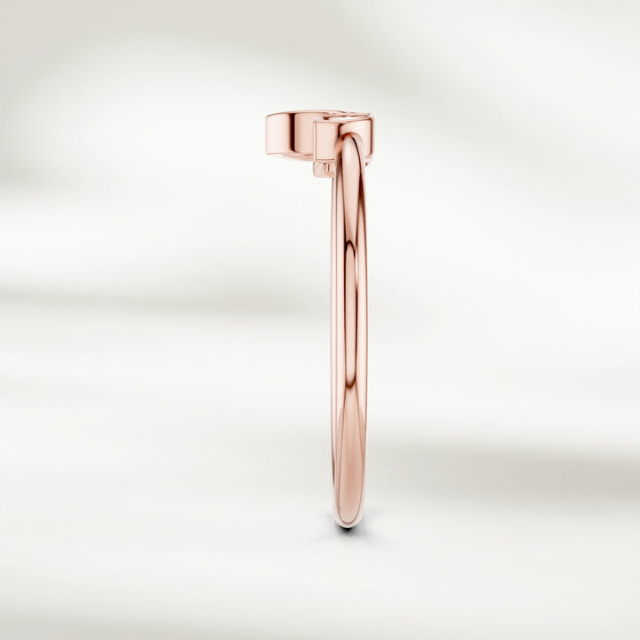 Side view of 9kt rose gold marquise diamond cluster ring with slim band and raised petal-inspired setting