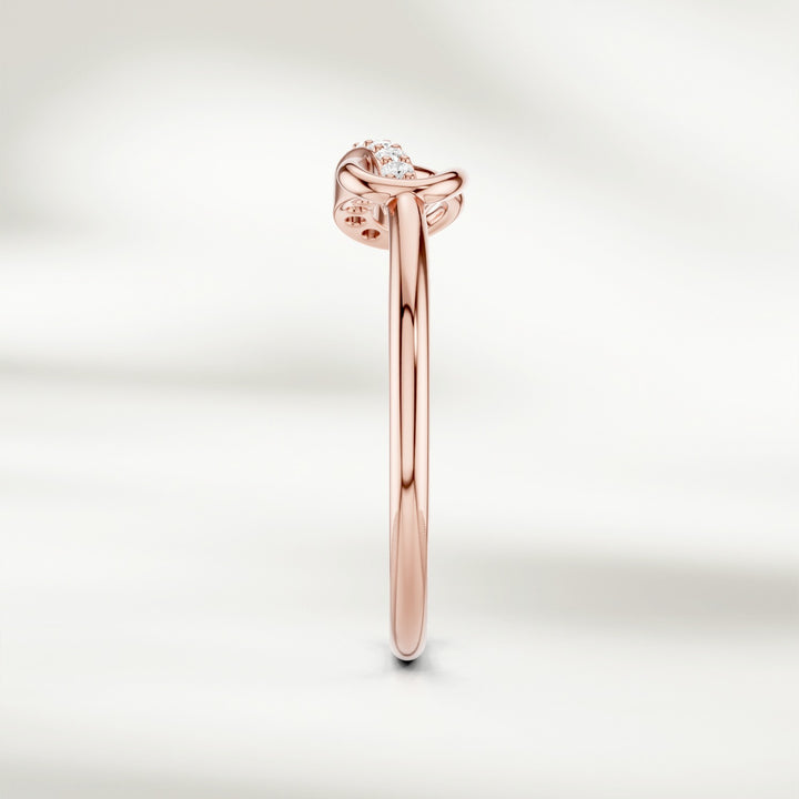 Side profile of gold infinity knot diamond ring with slim polished band