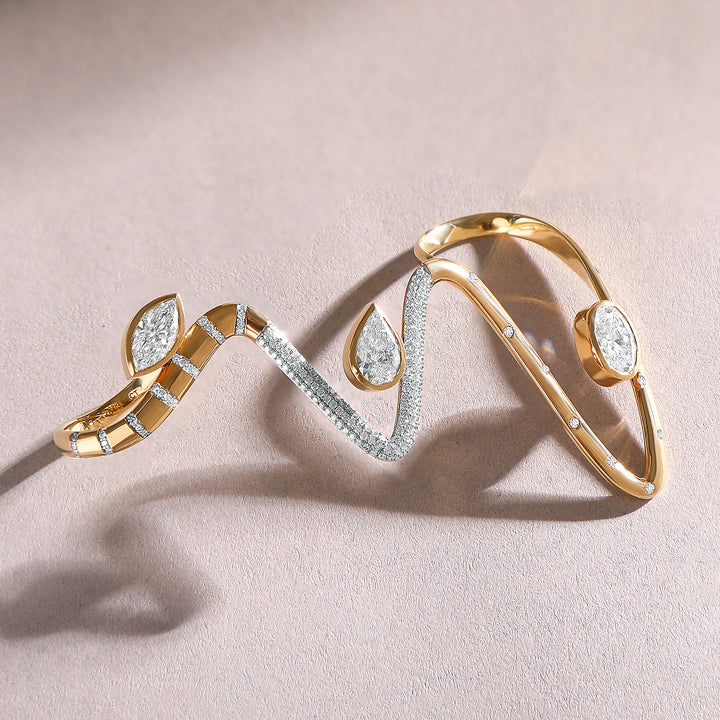 Flat lay of the Heartline 3.8 Ct Cuff Ring showing its fluid gold curves and pavé detailing.