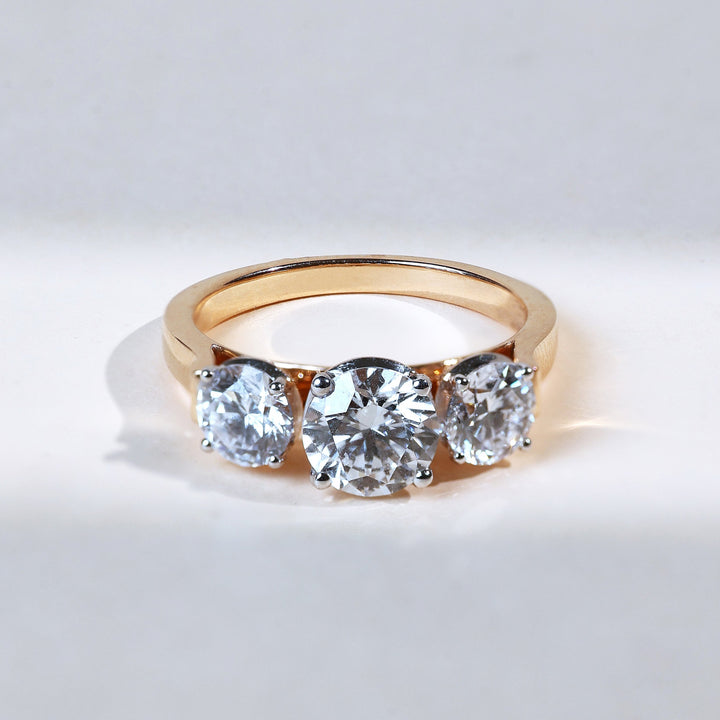 front view showing three round diamonds set on a gold band