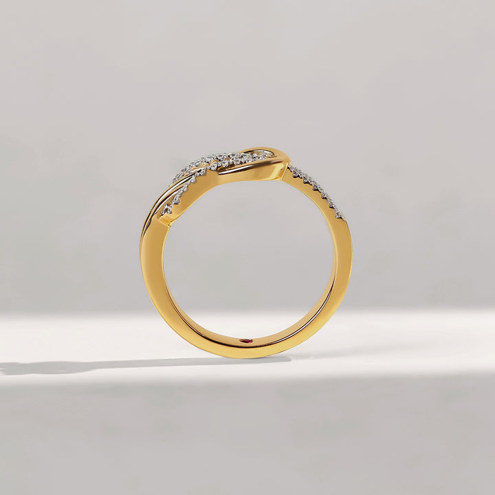 Gold ring with embedded diamonds on a light gray background