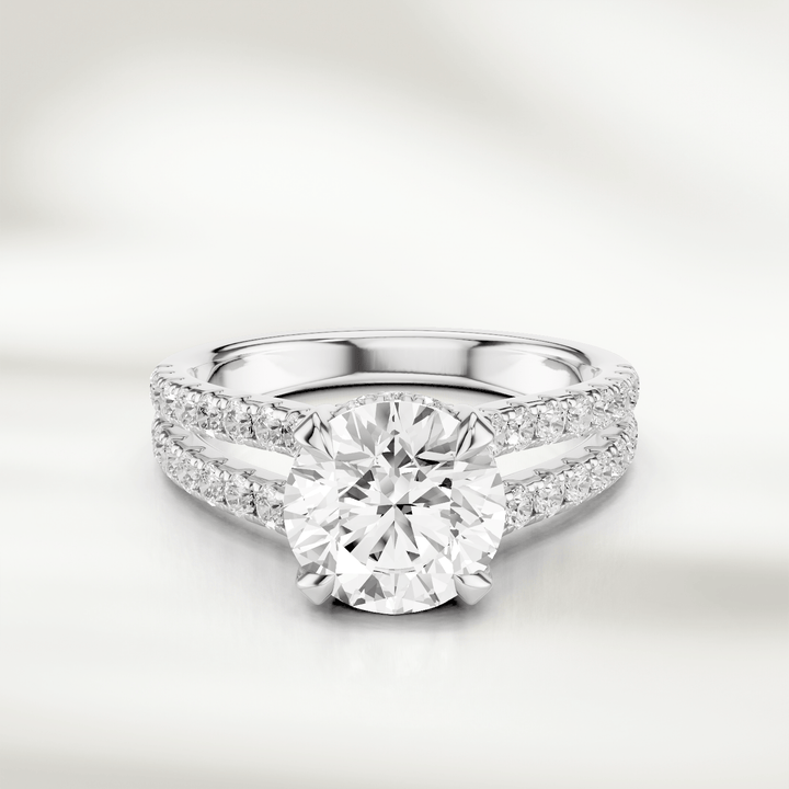 Front view of the 1 Ct Eira Solitaire Ring in white gold, featuring a round brilliant-cut diamond with a split shank accented by pavé diamonds.