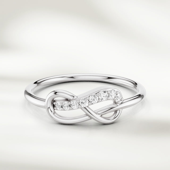 Infinity knot diamond ring in gold with slim polished band