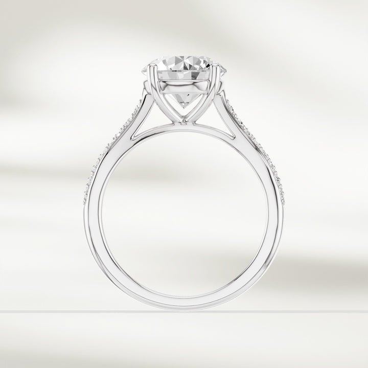 Profile view of the Infinite Love 2 Ct Round Solitaire Ring showcasing the pavé diamonds along the band