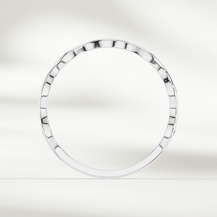 Top-down view of slim wavy diamond band ring in yellow gold
