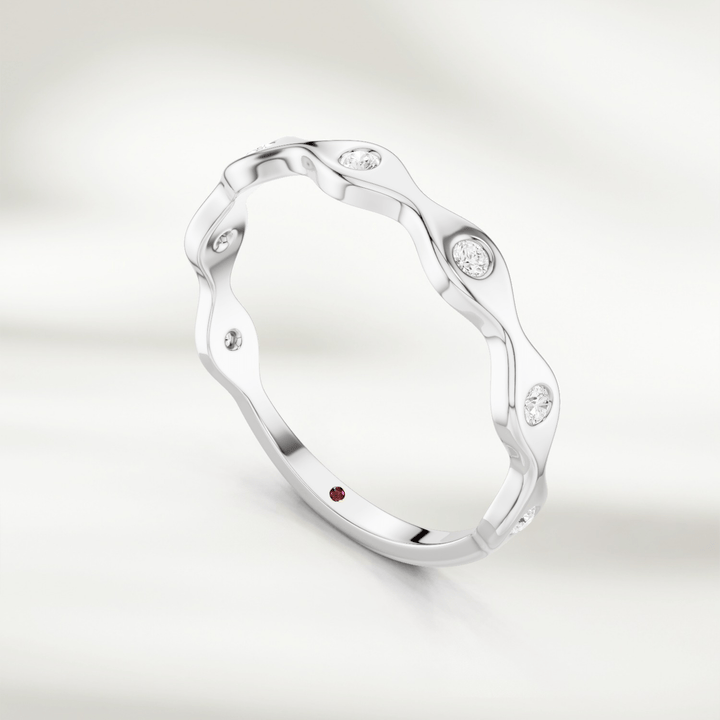 Yellow gold wavy diamond band ring with alternating curves and bezel-set stones