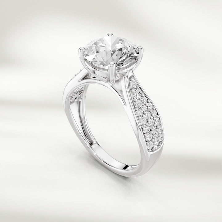 Angled view of the Infinite Love 2 Ct Round Solitaire Ring showing the pavé diamond detailing on the band.