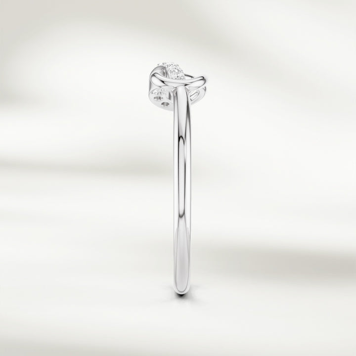 Side profile of gold infinity knot diamond ring with slim polished band