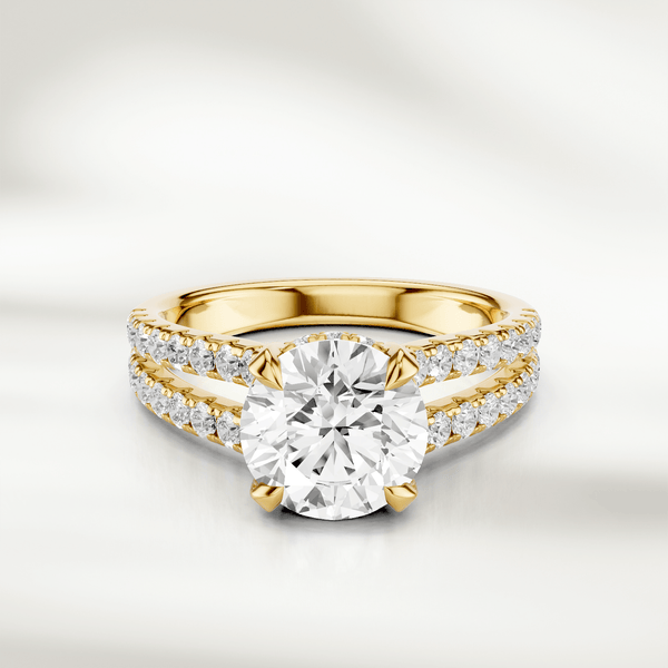 Front view of the 1 Ct Eira Solitaire Ring in yellow gold, featuring a round brilliant-cut diamond with a split shank accented by pavé diamonds.