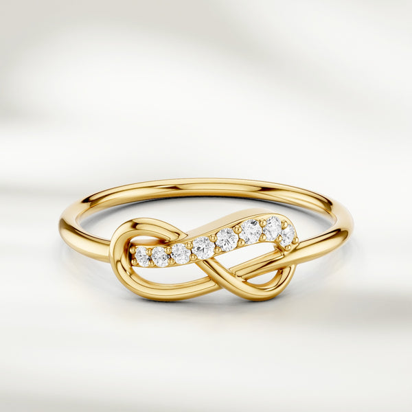 Infinity knot diamond ring in gold with slim polished band